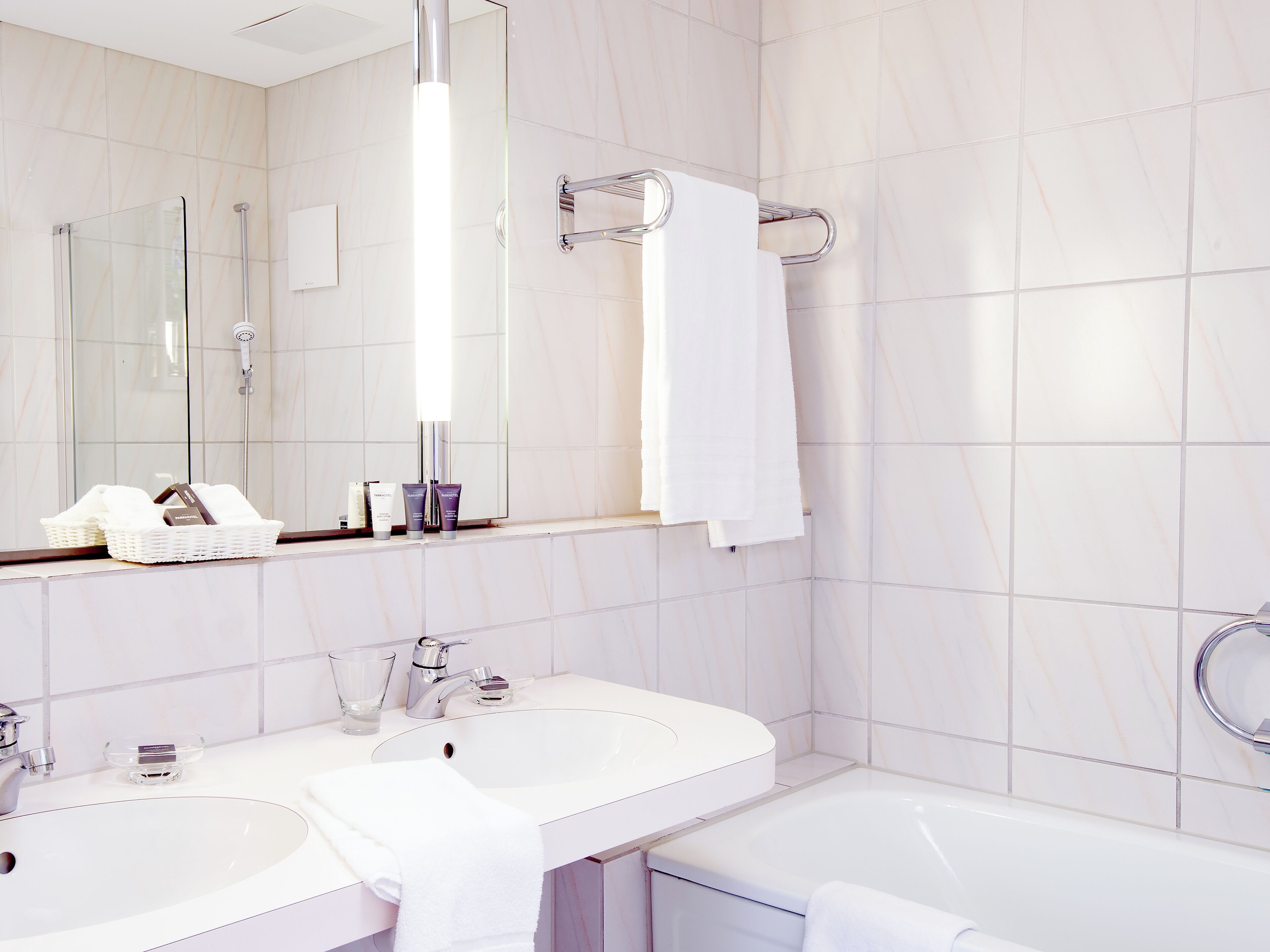 superior suite | bathroom | deep-soaking bathtub, designer toiletries, hair dryer, slippers