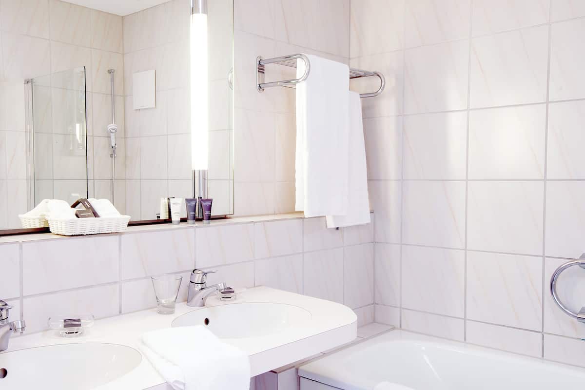 superior suite | bathroom | deep-soaking bathtub, designer toiletries, hair dryer, slippers