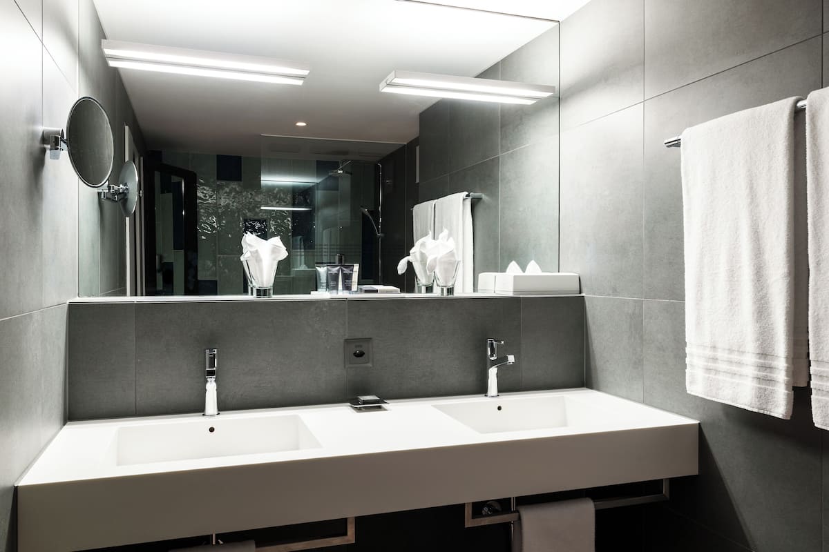 deep-soaking bathtub, designer toiletries, hair dryer, slippers