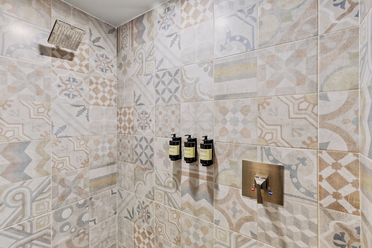Shower, rainfall showerhead, designer toiletries, hair dryer