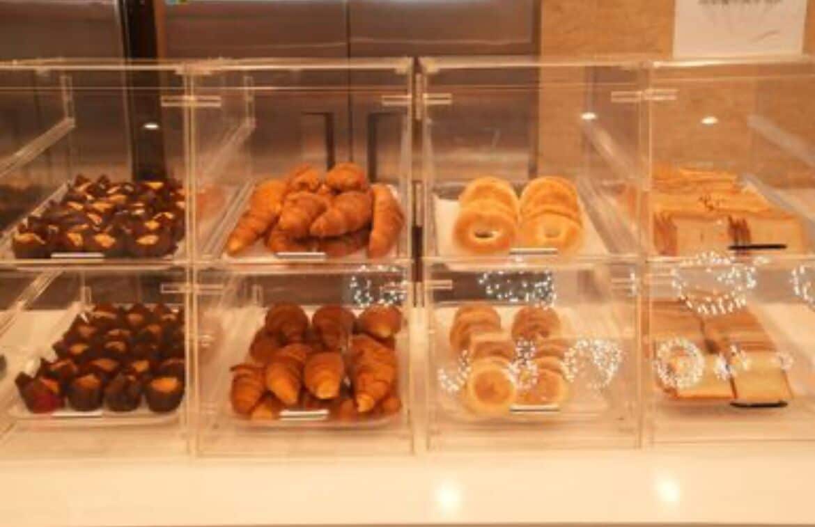 A bakery display case with various baked goods.