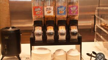 A beverage dispenser with four different flavors: Tootie Frutti, Corn Flakes, Frosted Flakes, and Raisin Bran.