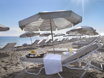 On the beach, white sand, beach cabanas, sun loungers at Grand Beach Hotel Surfside