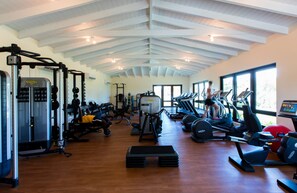 A gym with various exercise equipment, including treadmills, weight machines, and free weights. - Jumby Bay Island - Oetker Collection (Long Island)