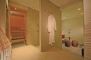 Bathroom features a glass shower enclosure, wooden bench, and wall-mounted towel rack.