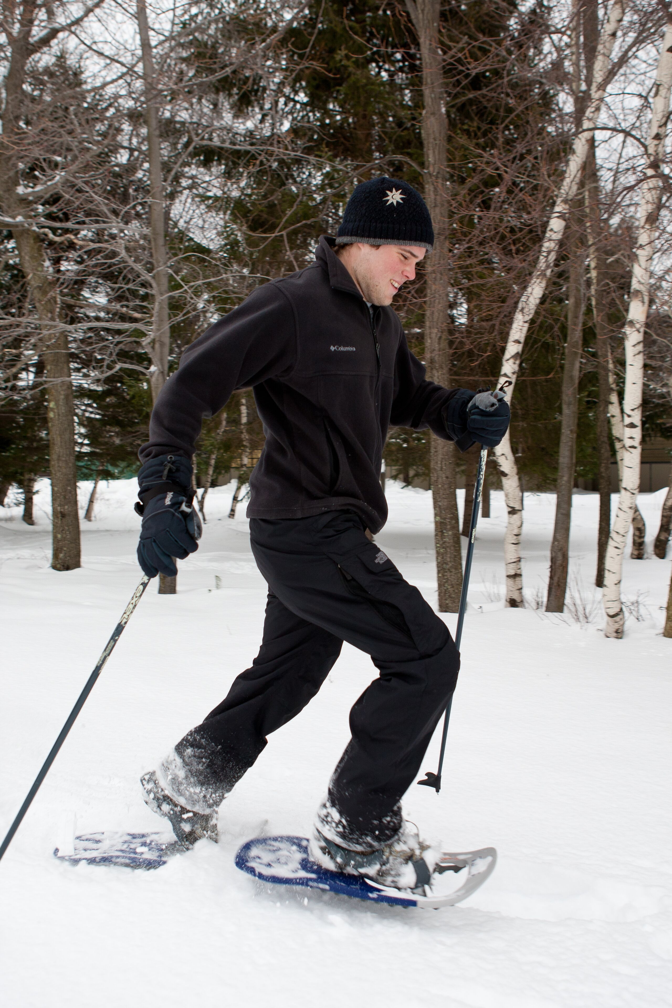 A person skiing in a snowy forest.