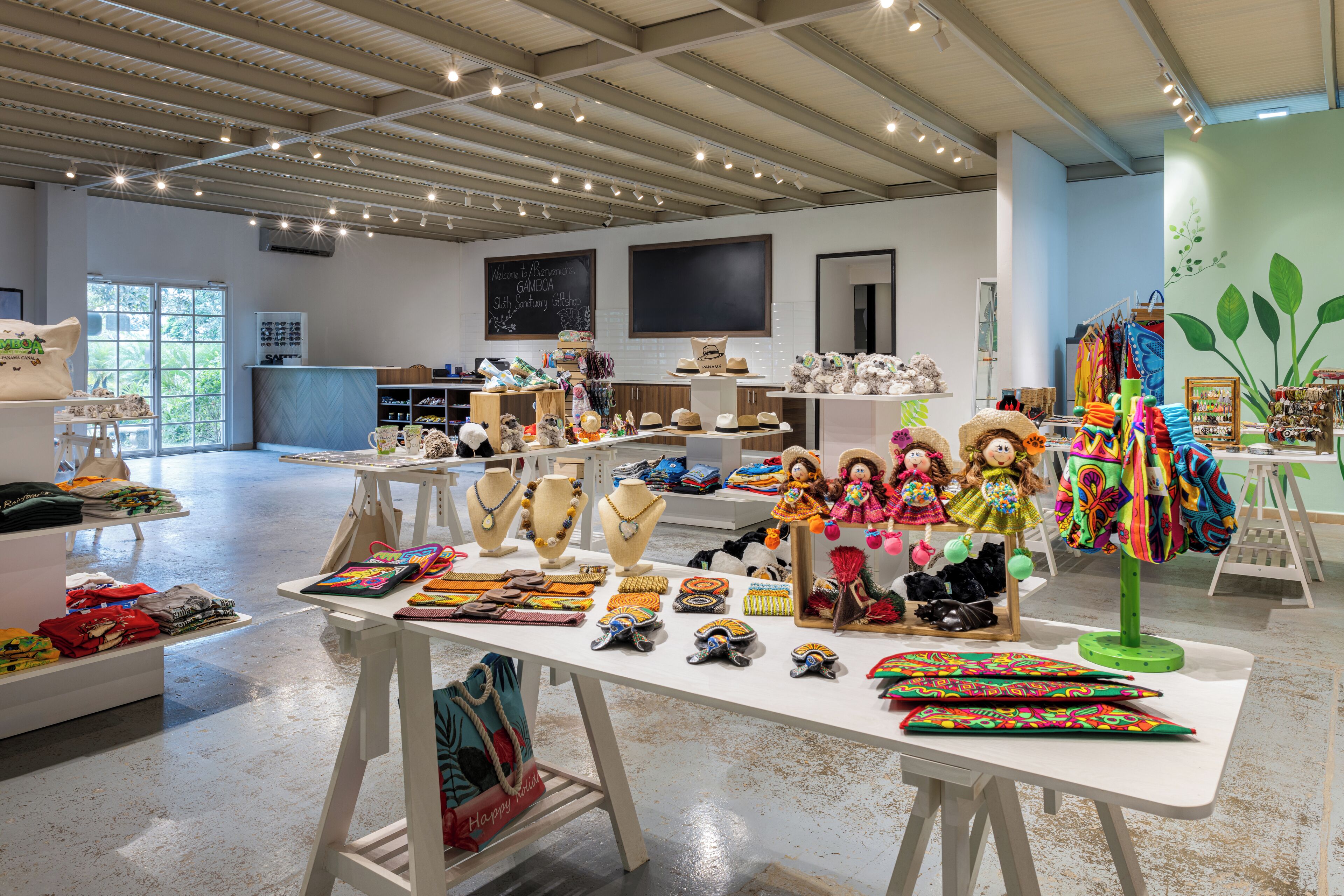 A spacious retail store with various items on display, including hats, jewelry, and dolls.