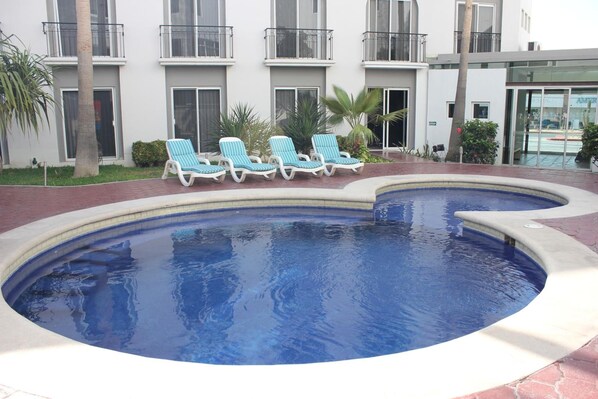 Outdoor pool, open 9:00 AM to 9:00 PM, pool loungers