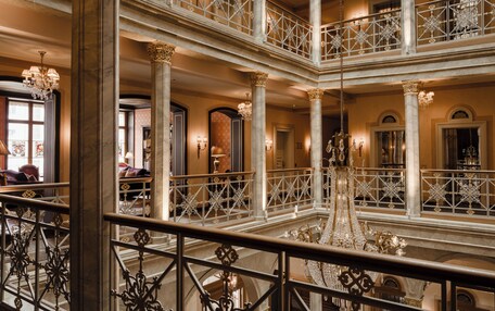 A multi-level atrium with ornate railings and chandeliers.