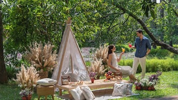 Enjoy a serene picnic in our garden, surrounded by lush greenery and vibrant flowers.