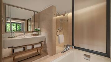 A modern bathroom with a large mirror, a bathtub, and a shower area.