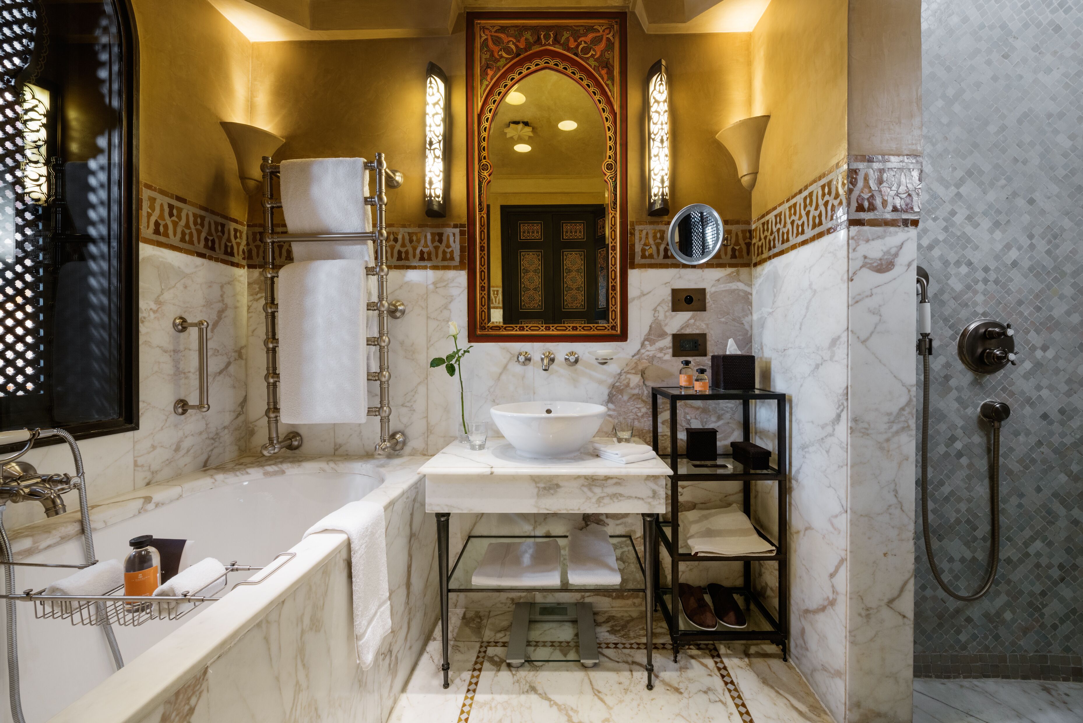 A luxurious bathroom with a large bathtub, a white sink, and a walk-in shower.