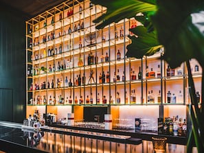 A bar area with shelves of liquor bottles and glasses.