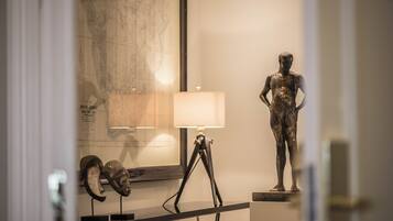A museum exhibit with a map, a lamp, and a statue.