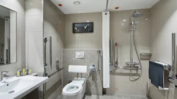 A modern bathroom with a toilet, sink, and shower.