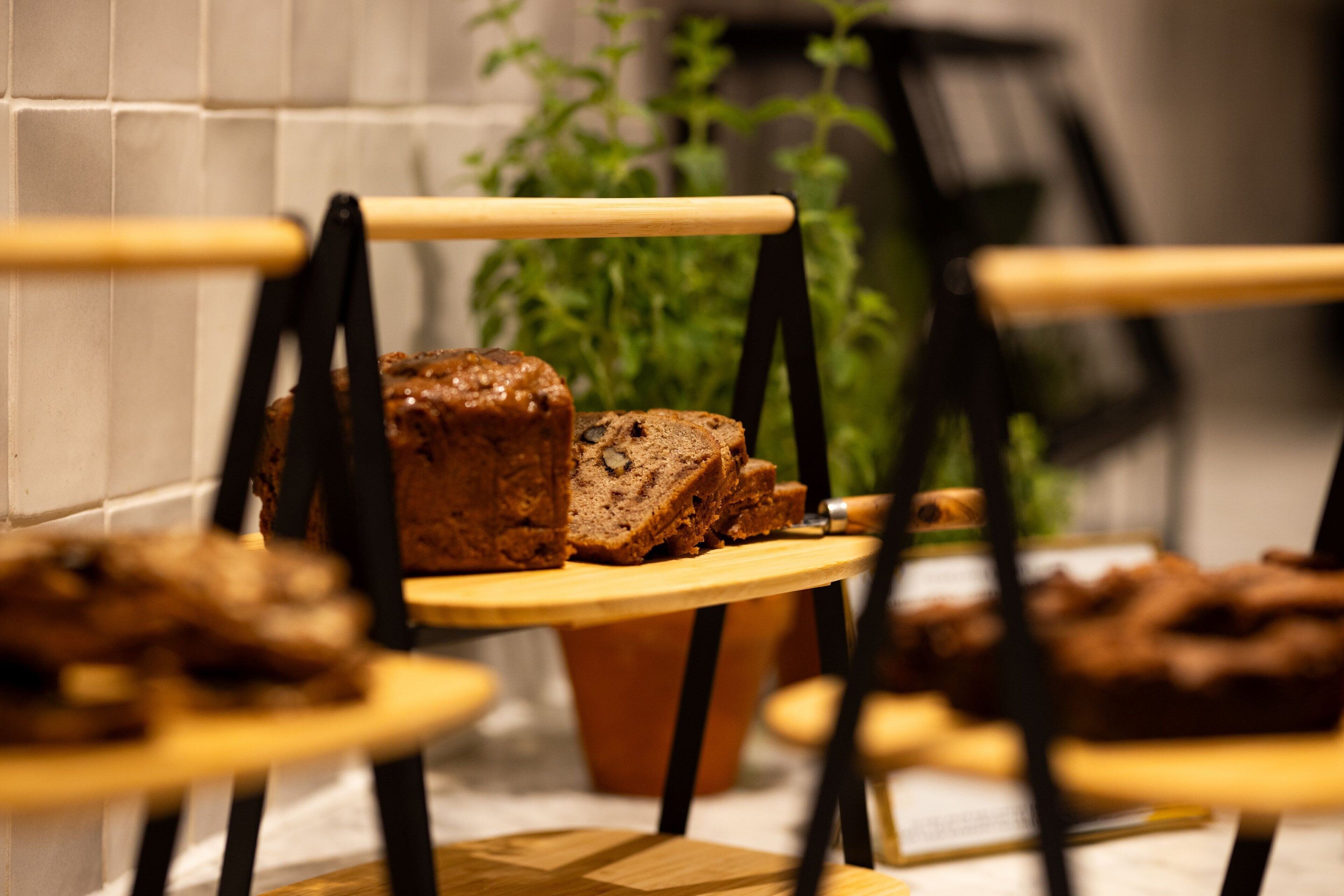 A display of various breads on wooden stands in a kitchen setting.