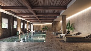 A modern indoor pool area with a wooden ceiling, stone flooring, and lounge seating along the pool. - Hacienda Son Antem Golf Resort, Autograph Collection (Llucmajor)