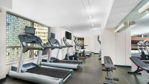 A gym with treadmills, ellipticals, and free weights. - Millennium Premier Hotel New York Times Square (New York)
