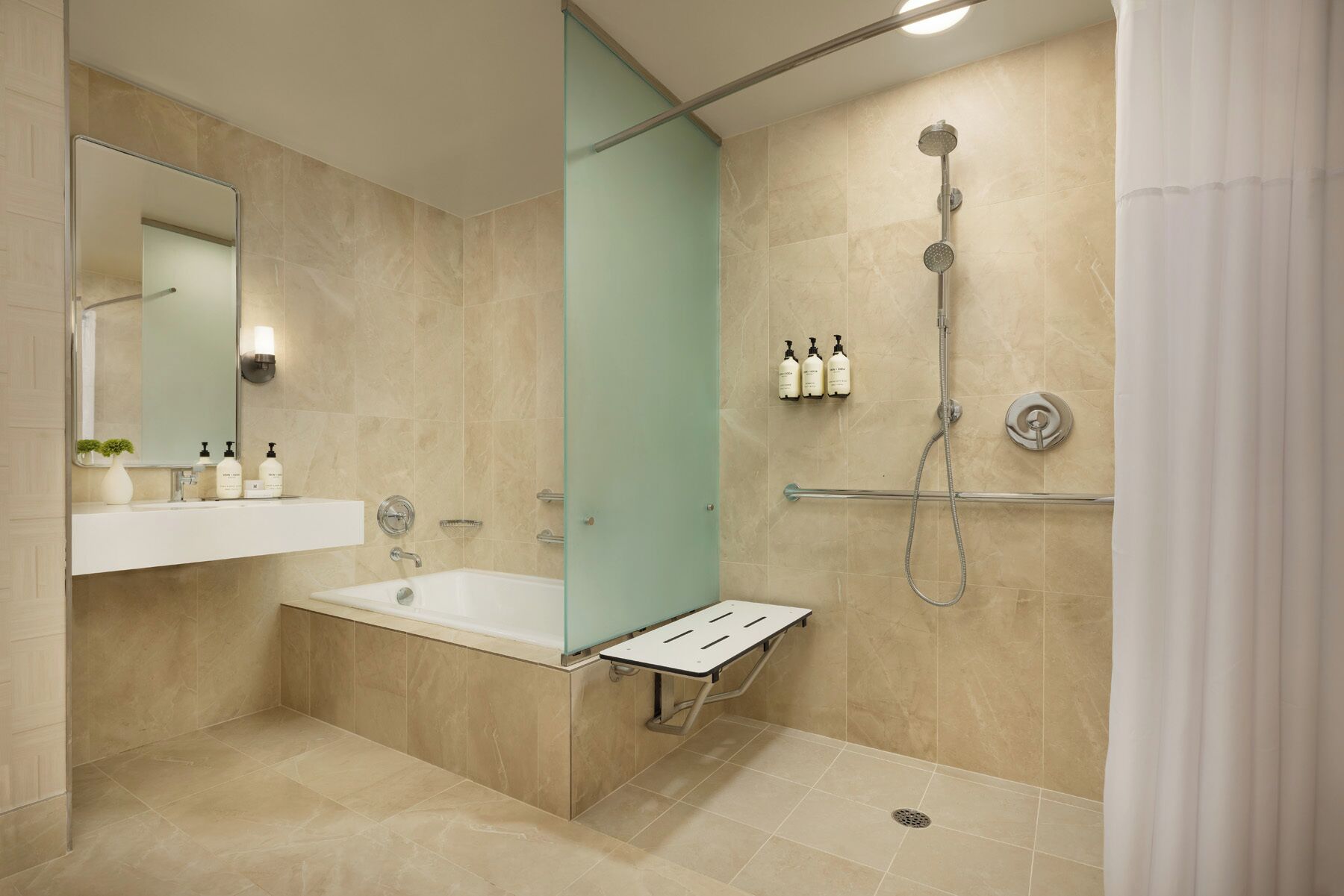A modern bathroom with a bathtub, a shower, and a vanity with a mirror.
