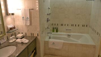 A bathroom with a sink, mirror, towel rack, shower, and bathtub.