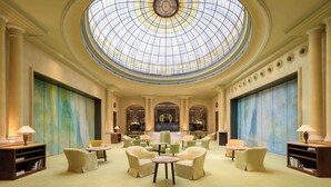 A spacious lobby with a large skylight, comfortable seating, and a grand staircase. - Hotel Bayerischer Hof - The Leading Hotels of the World (Munich)