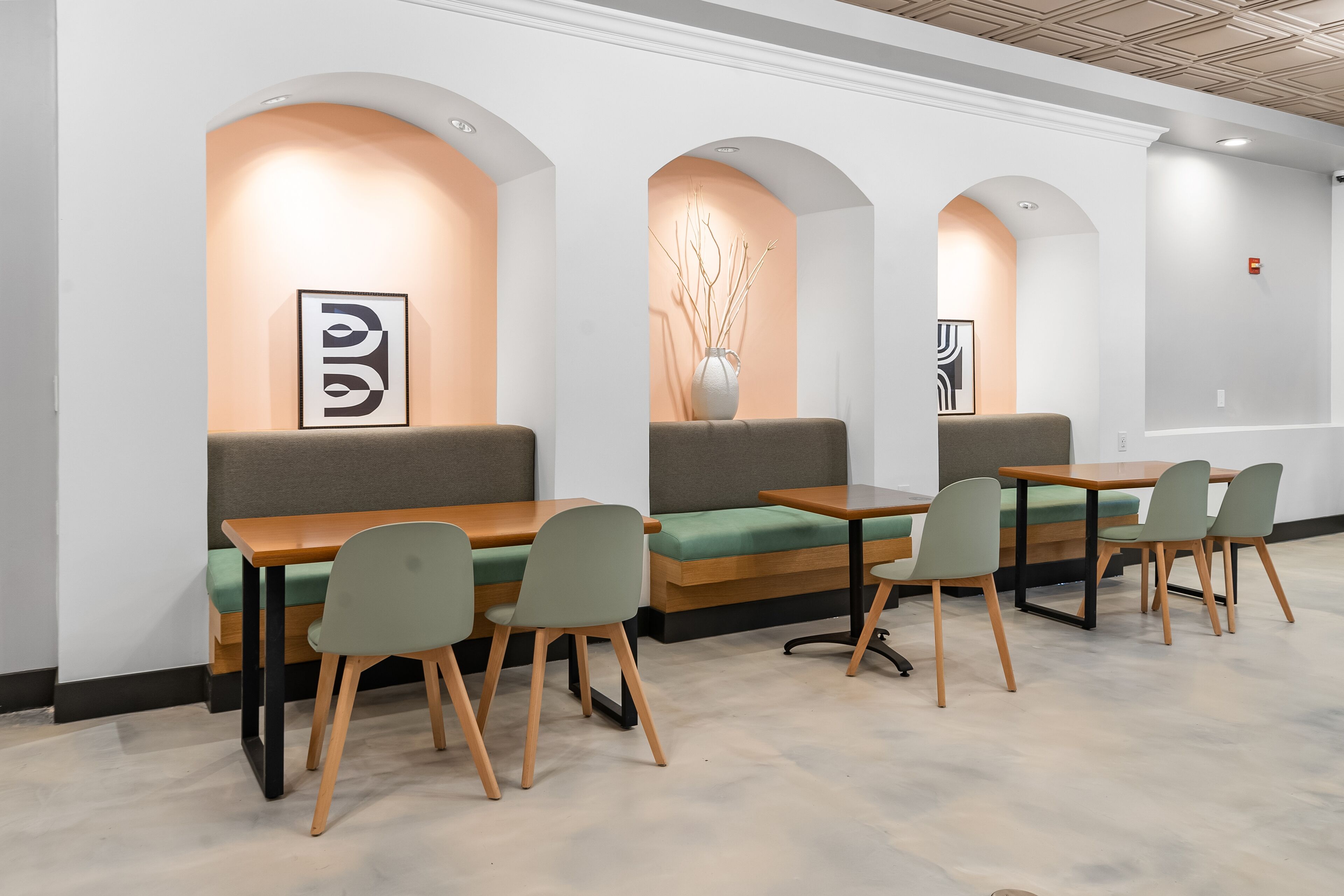 A modern interior with seating arrangements, tables, and decorative elements.