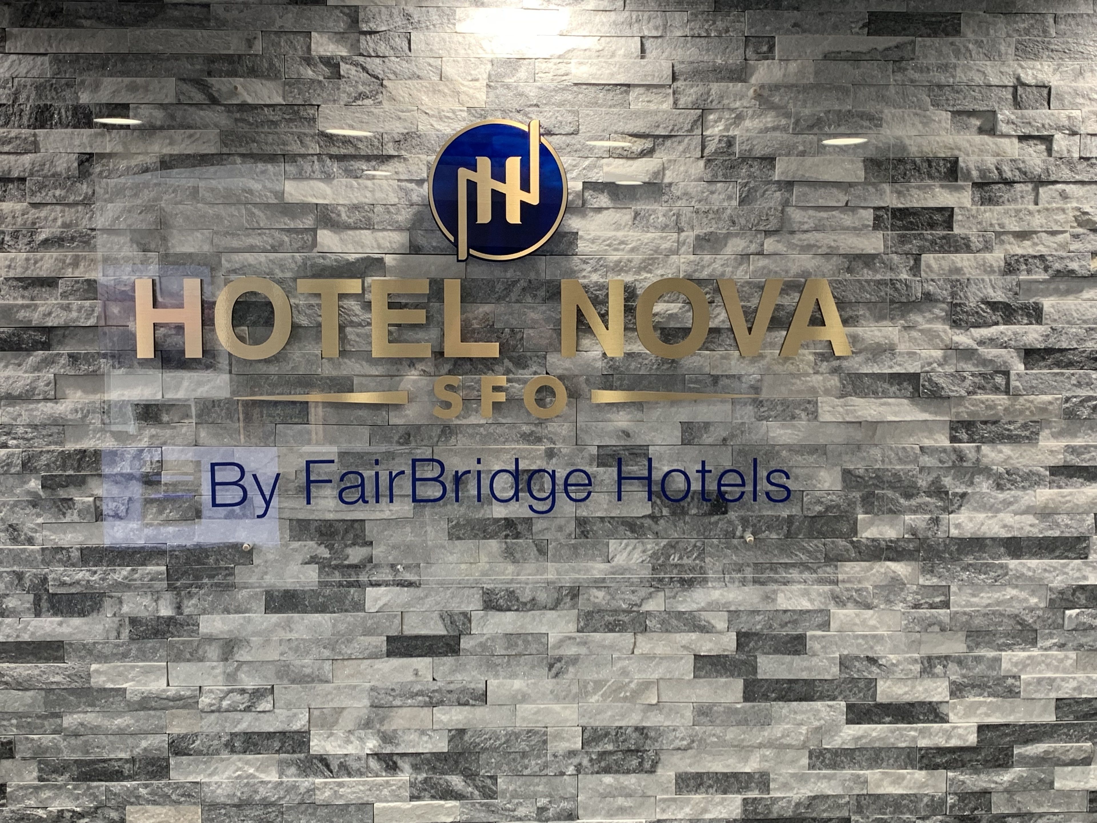 A hotel sign with the name "HOTEL NOVA" and a logo above it.