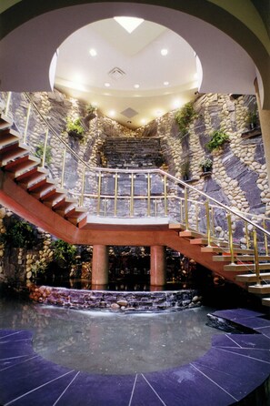 A grand staircase with a glass railing leading to a high ceiling. - Four Points by Sheraton Edmonton South (Edmonton)