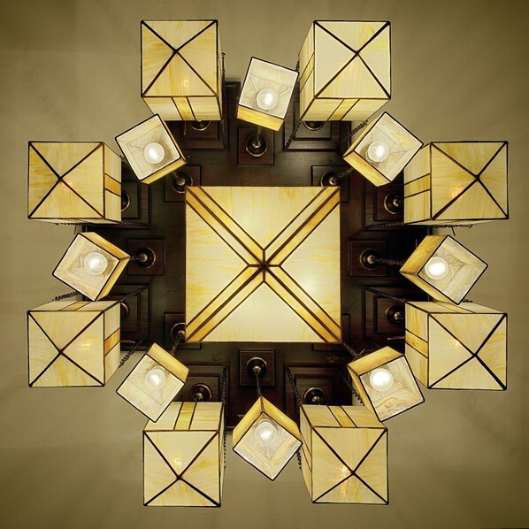 A symmetrical chandelier with multiple square light fixtures arranged in a circular pattern around a central square light fixture. - TRYP by Wyndham Kassel City Centre (Kassel)