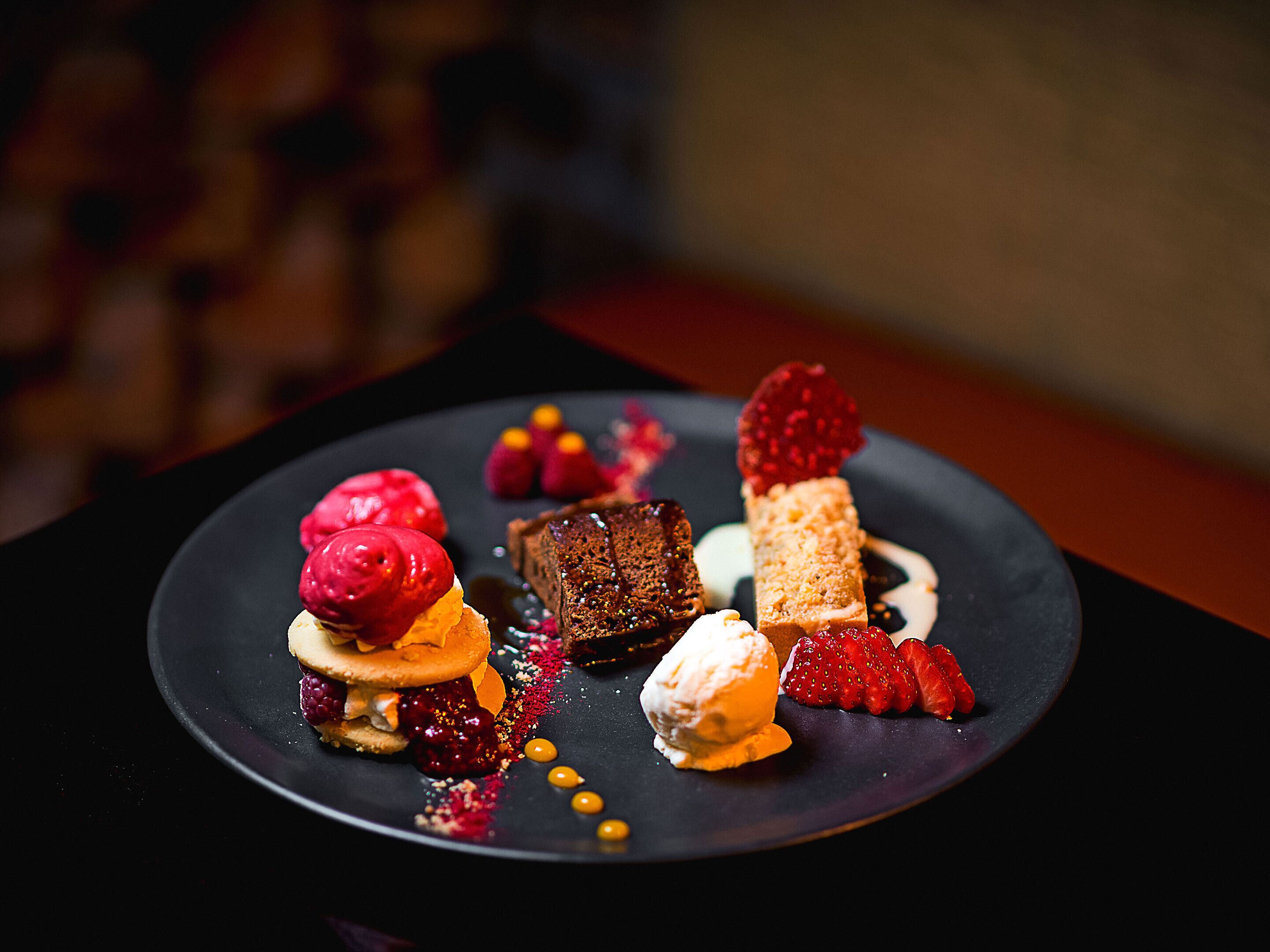 A dessert plate with various sweet treats and garnishes.