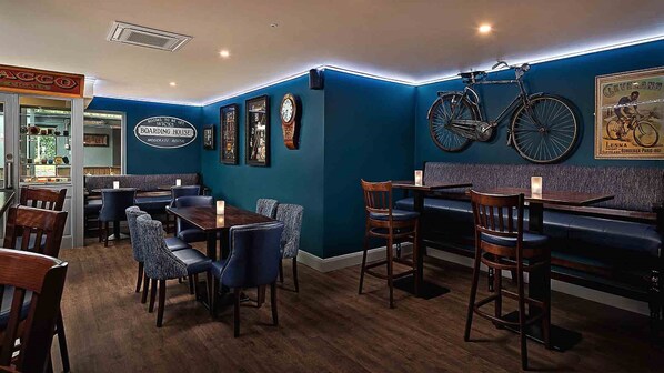 A restaurant with a blue wall, wooden furniture, and vintage bicycles. - Shannon Springs Hotel (Shannon)