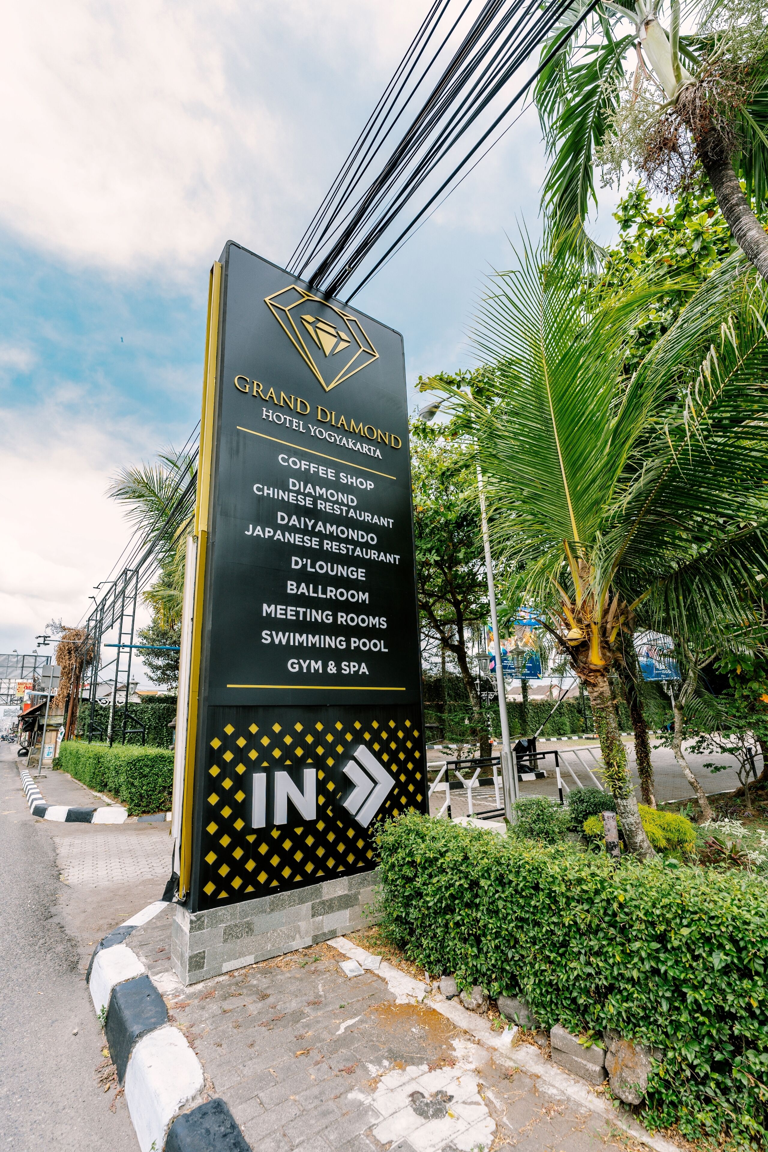 Bord voor het Grand Diamond Hotel Yogyakarta met faciliteiten zoals een koffiehuis, restaurants, lounge, balzaal, vergaderruimtes, zwembad en spa.