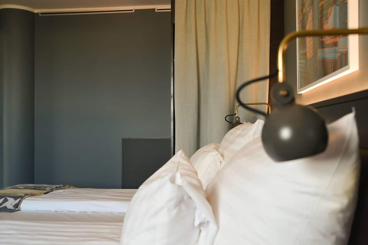 hypo-allergenic bedding, desk, laptop workspace, blackout curtains