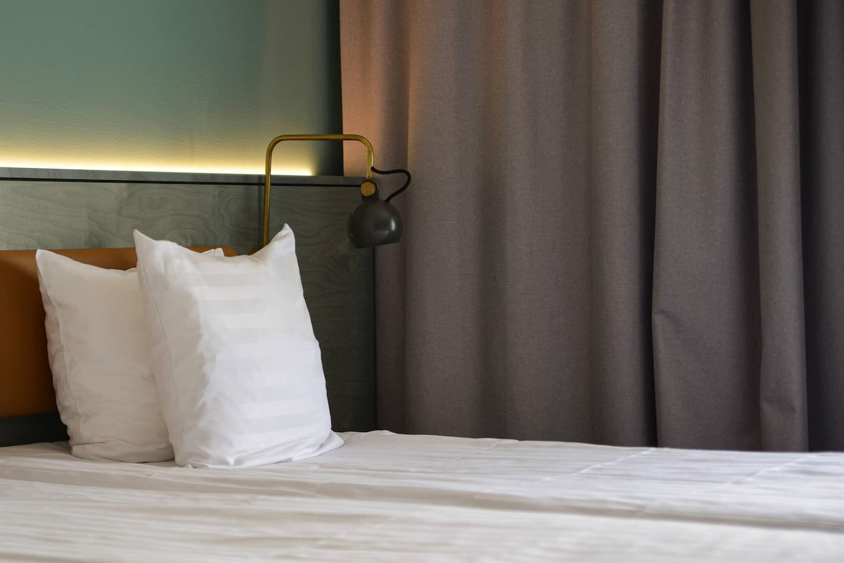 Hypo-allergenic bedding, desk, laptop workspace, blackout curtains