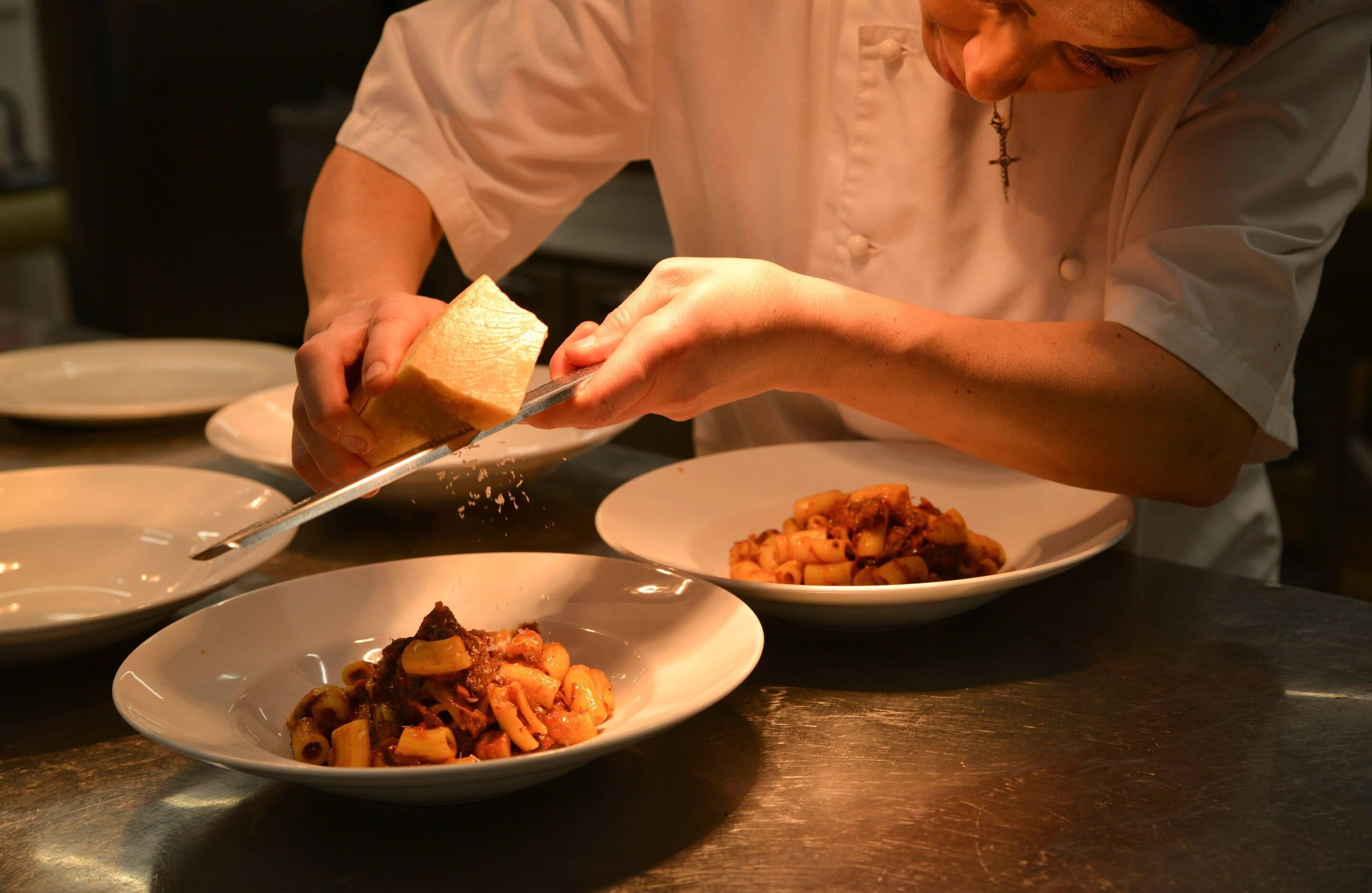 A person serving food on plates.