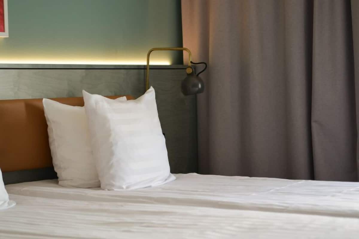 Hypo-allergenic bedding, desk, laptop workspace, blackout curtains