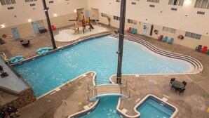 An indoor swimming pool with multiple lanes, a children's play area, and lounge chairs. - Holiday Inn Lethbridge by IHG (Lethbridge)