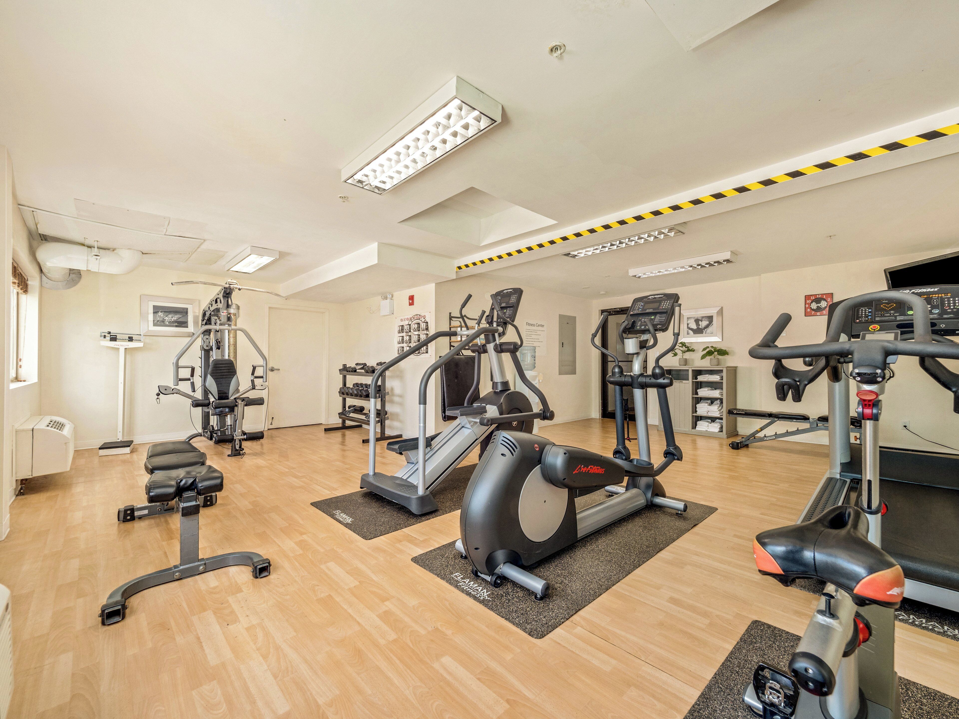 A gym with various exercise equipment, including treadmills and weight machines.