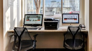 A workspace with two computers, a printer, and two mesh chairs. - Holiday Inn Express Washington DC N-Silver Spring by IHG (Silver Spring)