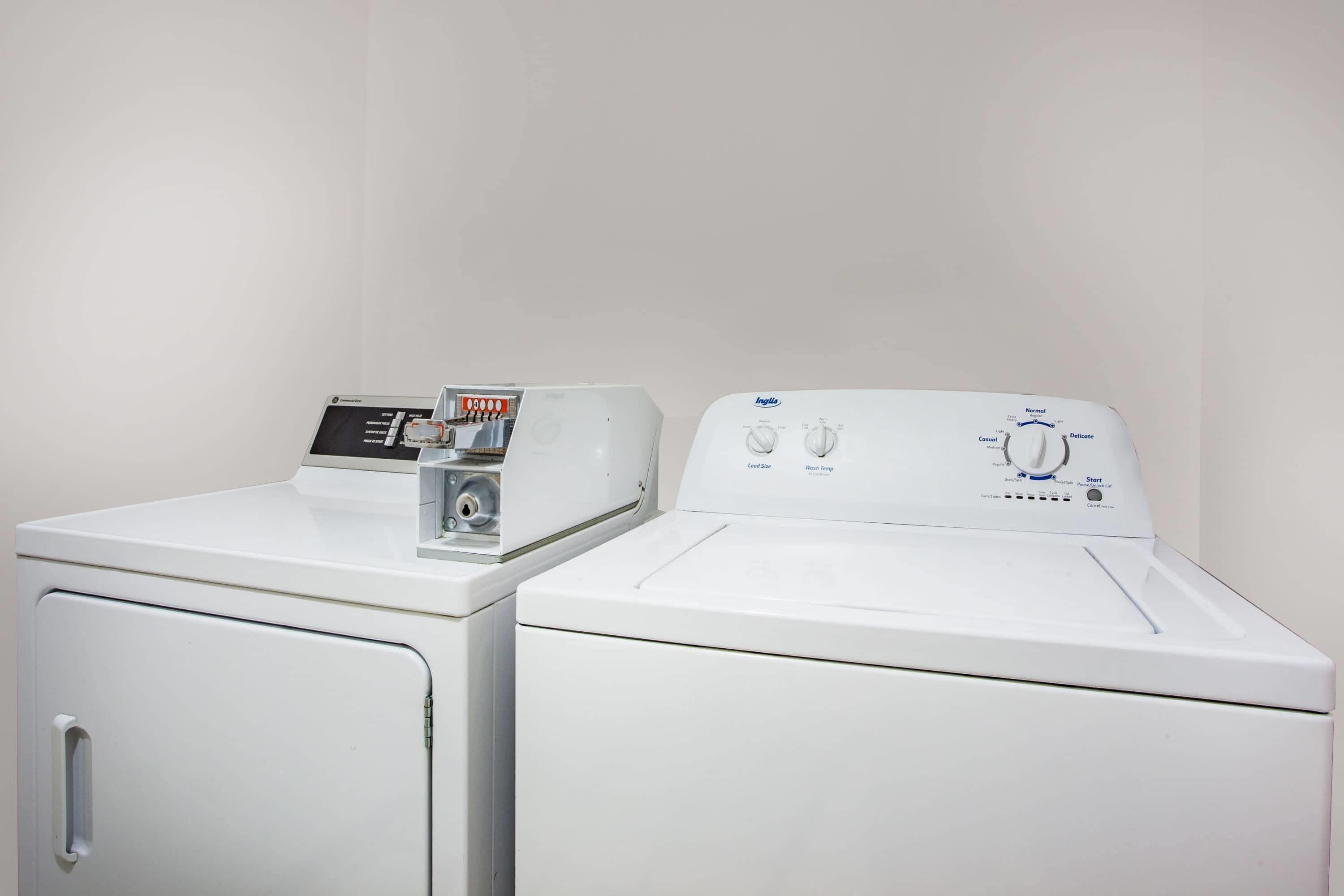 Two white front-loading washing machines with control panels.