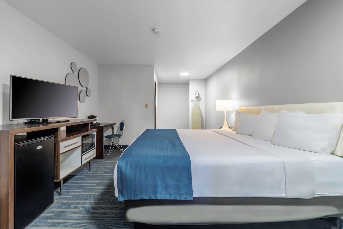 Premium bedding, desk, laptop workspace, blackout curtains