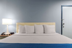 Premium bedding, desk, laptop workspace, blackout drapes