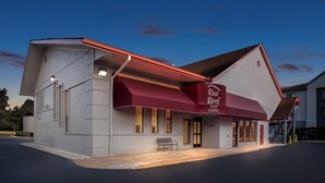 A modern building with a red awning and a sign that reads "Red Roof Lobby." - Red Roof Inn Ann Arbor - U of Michigan South (Ann Arbor)