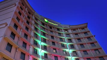 A multi-story hotel building with a prominent Holiday Inn sign.