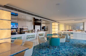 A modern hotel lobby with a bar area, seating arrangements, and a patterned carpet. - Regal Airport Hotel (Chek Lap Kok)