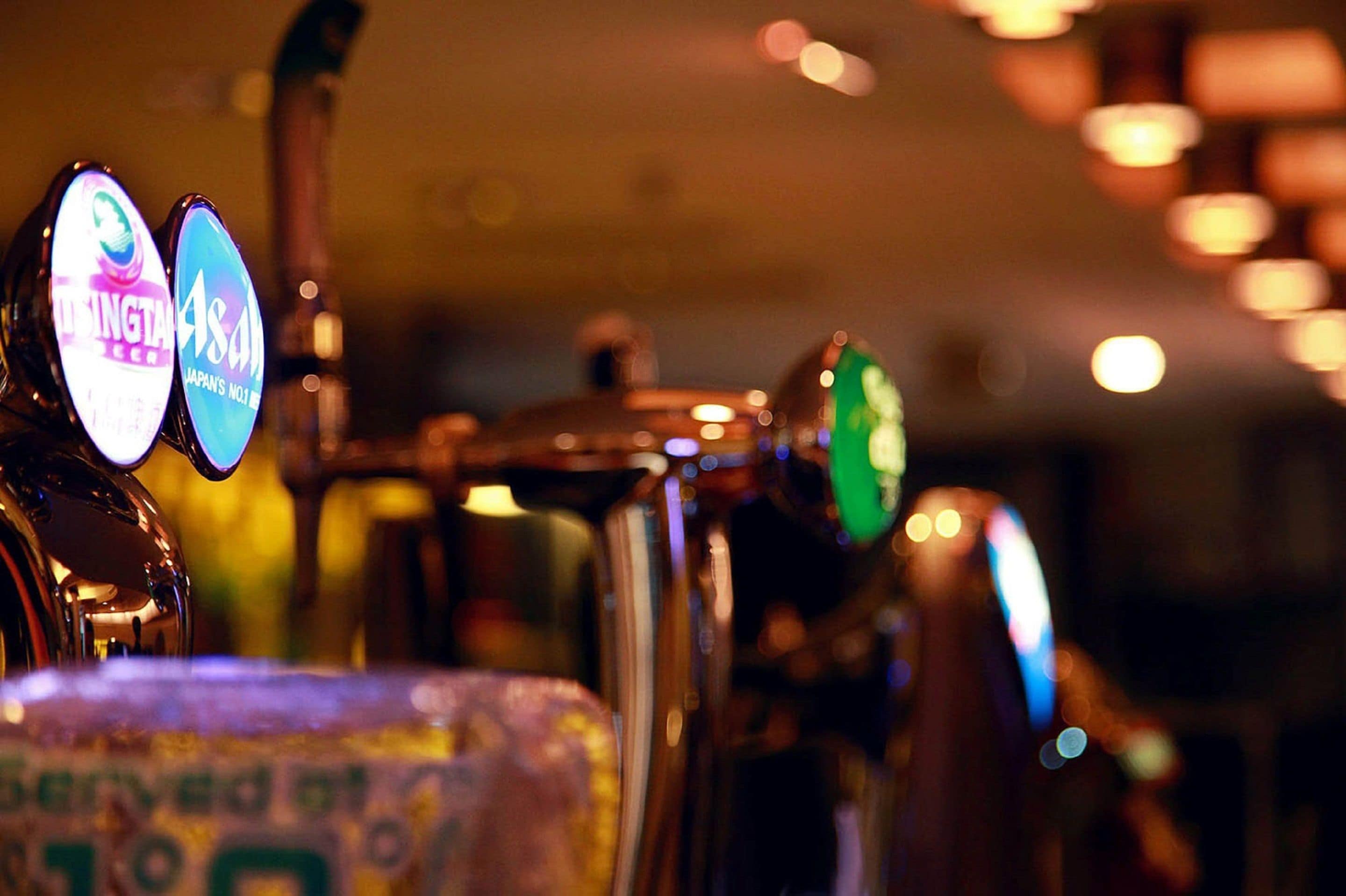 A bar with illuminated beer taps labeled "Dingta Beer" and "4AS."