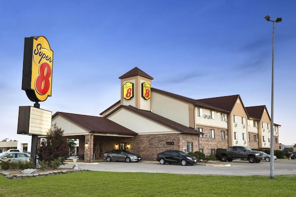 A hotel with a Super 8 sign, multiple parking spaces, and a brick facade. - Super 8 by Wyndham Carbondale (Carbondale)