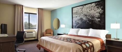 A hotel room with a large bed, a desk, a chair, a window with curtains, a wall-mounted TV, and a large painting.