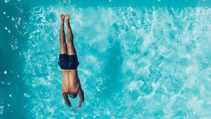 A person floating in a clear blue pool. - Loyal Duke Lodge (Salida)