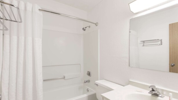 A bathroom with a bathtub, toilet, and sink.